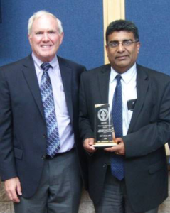 Abraham Pannikottu and Jon Gerhardt holding the American Engineering Group LLC's Award
